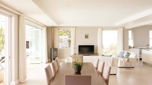 General view of light modern interiors with dining room table and chairs, copy space, slow motion