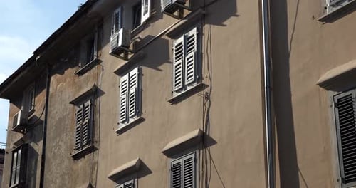 Traditional houses in old Mediterranean town with windows with shutters in spring sunny morning.
