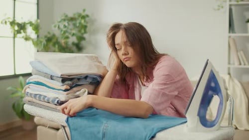 Tired Woman with Ironing in Domestic Setting