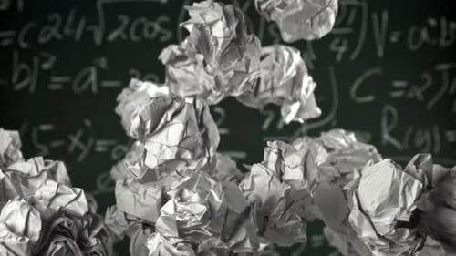 Crumpled Paper Rises and Falls Against the Background of the Blackboard Filmed on a Highspeed Camera