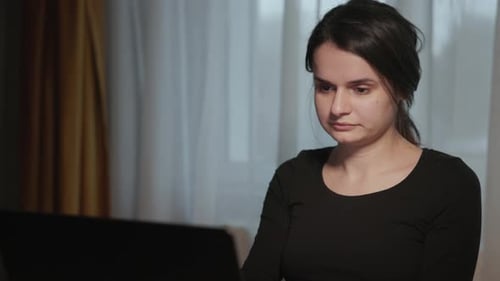 Close Up Of Woman Working On Her Laptop At Home