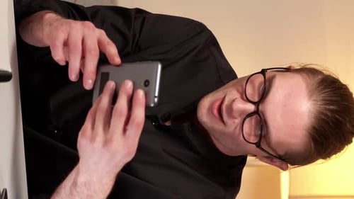 Man Celebrates While Looking At Mobile Phone