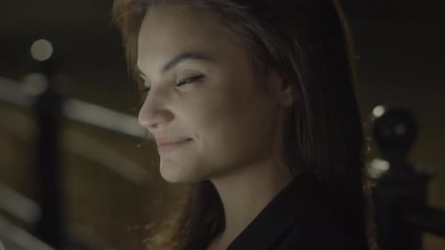 Young Woman Using Tablet Computer In The Park At Night