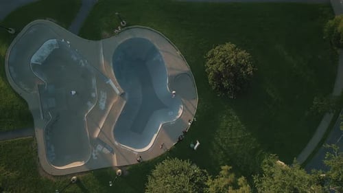 Aerial View of a Skate Park and Young Guys Doing Tricks on a Skateboard