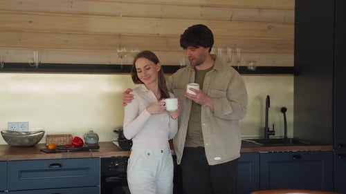 Loving Couple Enjoying Coffee in a Modern Kitchen