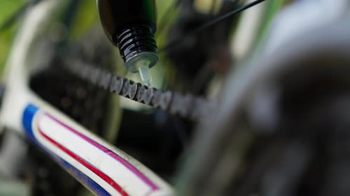 Close-up POV camera bicycle chain lubrication, bike maintenance in cycling workshop