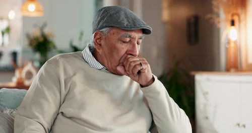 Elderly Man Coughing and Holding Chest in Pain