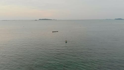 Aerial view of sunset over calm sea with fishing boats, Indonesia.