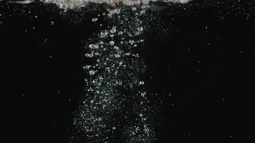 Bell Pepper Falling into Water on Black Background