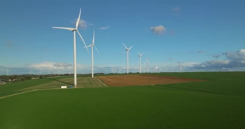 Wind Turbines Spinning in Rural Green Field Aerial