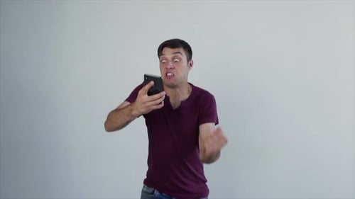 Excited Man Celebrating Success After Good News on Phone