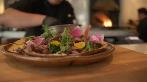 Chef prepares delicious gourmet tostadas in restaurant