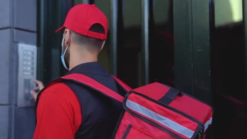 a delivery man with a red backpack ringing bell