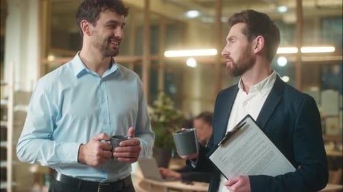 Office Colleagues Talking with Coffee in a Modern Workplace