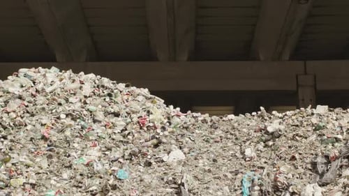 Mountain with dunes of trash, dunes of bottles, cans, cans, glass, stones, shards, ceramics, windows