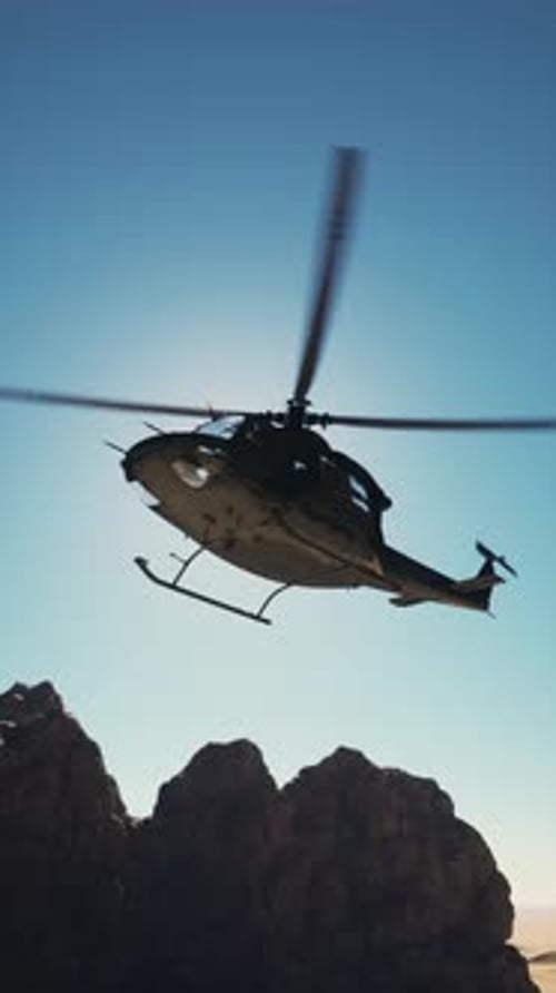 Helicopter Flying Over Mountain Range