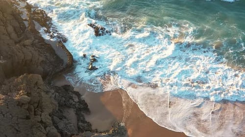 Sandy Beach on the Atlantic Ocean Surrounded By Rocky Stones Aerial View