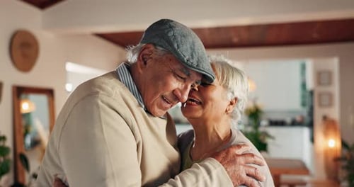 Senior Couple Embracing and Laughing at Home