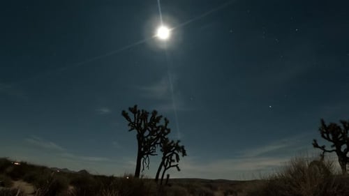 Day-to-night-to day holy grail time lapse of the Mojave Desert and full moon, stars and cloudscape w