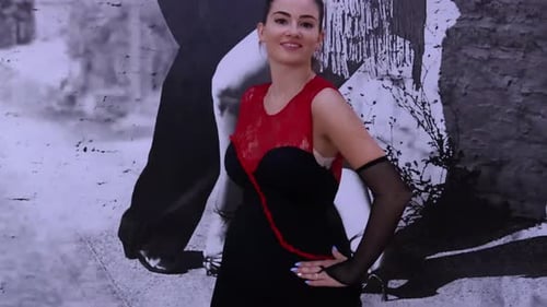 Young Woman Dancing in Black and Red Outfit