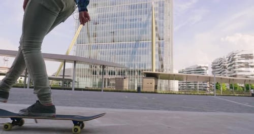 A boy practices skateboarding in the middle of the city, between buildings and skyscrapers. Concep
