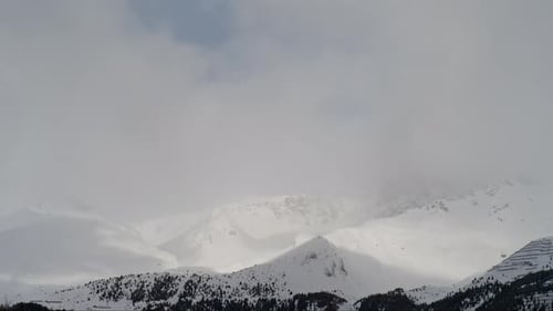 Cloud Timelapse Over Snowy Peaks