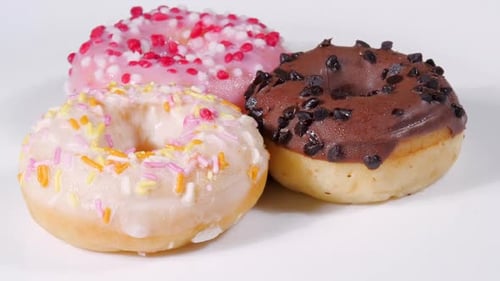 Tasty Donuts Rotation on a White Background. Unhealthy Sweet Food Dessert. Chocolate Doughnut