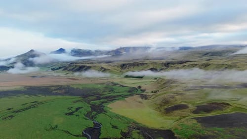 Aerial View of Iceland Displays Stunning Landscape with Clouds Mountains Showcasing Natural Beauty