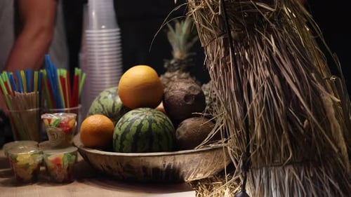 Tropical Fruits in Wooden Bowl with Straw Hut