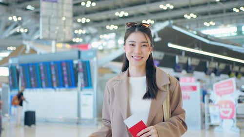Portrait of Asian young girl walk in airport terminal to boarding gate.