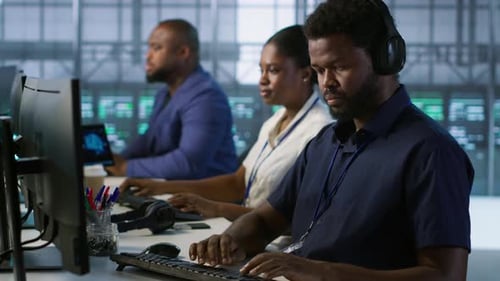 Data Center Admin Typing on Keyboard Maintaining Company Infrastructure