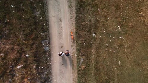 Tourist Couple And A Dog Trekking On Mountain Trail In Piedmont, Italy On A Sunny Day In Autumn. aer