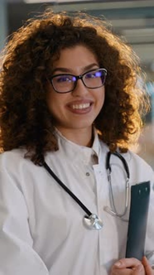 Smiling Woman Doctor with Stethoscope and Curly Hair