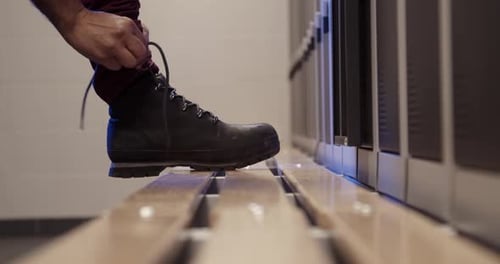 Man Tying Shoelaces in Changing Room