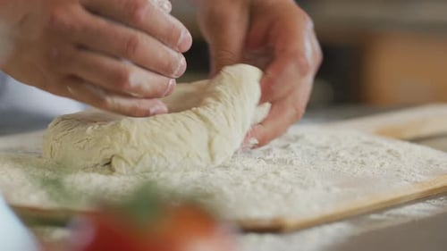 Close Up of Hands Preparing Fresh Pizza Dough Baker