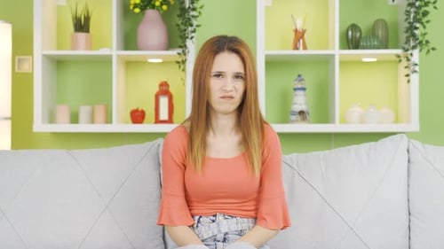 Distraught Woman Sitting on a Couch