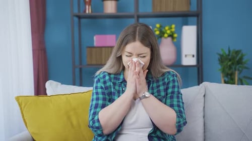 Woman Sick With Cold Blowing Her Nose