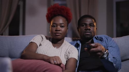 Couple Relaxing at Home Watching Television at Night