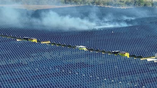 Dangerous Wild Fire at Sustainable Electric Power Plant with Many Rows of Solar Photovoltaic Panels