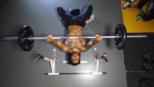 Strong Black Sportsman Doing Bench Press Workout with a Barbell at Sport Club Muscular Athlete Doing