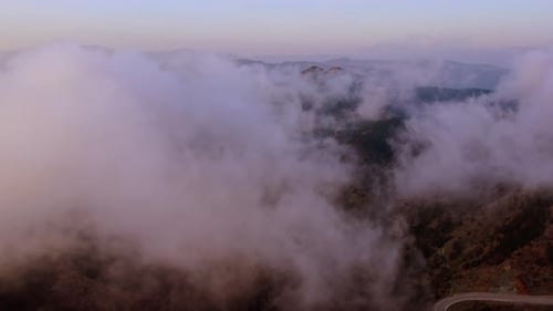 Aerial View of Fog Moving Over Mountain Ridges
