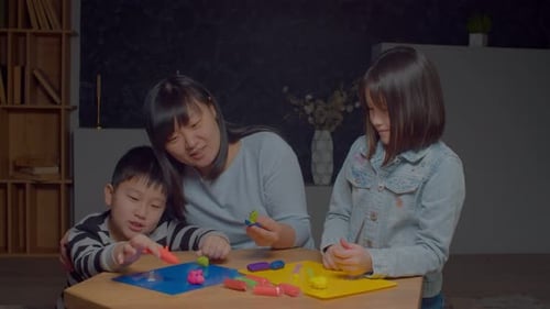 Mother with Children Making Clay Crafts at Home