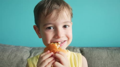 Happy Child Eating Sandwich at Home
