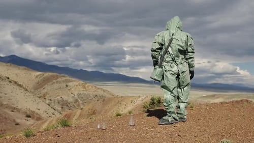 An Ecologist a Biologist in a Protective Suit is Studying the Area to Conduct Soil Quality Control