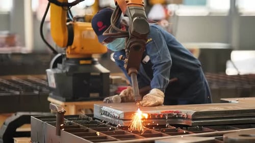 Woman welder technical with gloves manual robotic arm welding automotive components with precision s