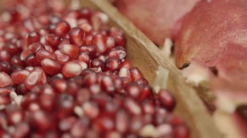 Close up Panning of Pomegranate seeds inside of a plate juicing and using fresh ingredients and fres