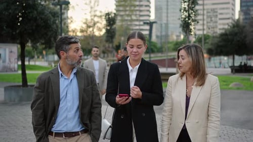 Business People Walking and Talking in City