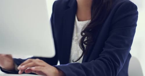 4k video of an attractive young businesswoman working on a computer in an office