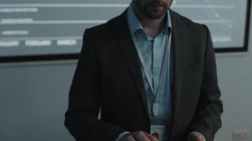 Man Uses Tablet in Front of Line Chart