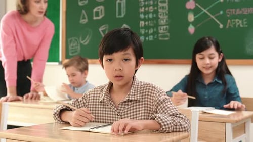 Children Learning in Classroom with Teacher at School